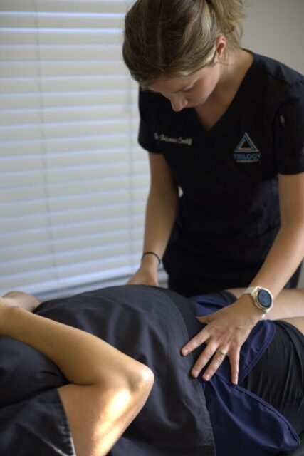 a woman massaging a woman's back