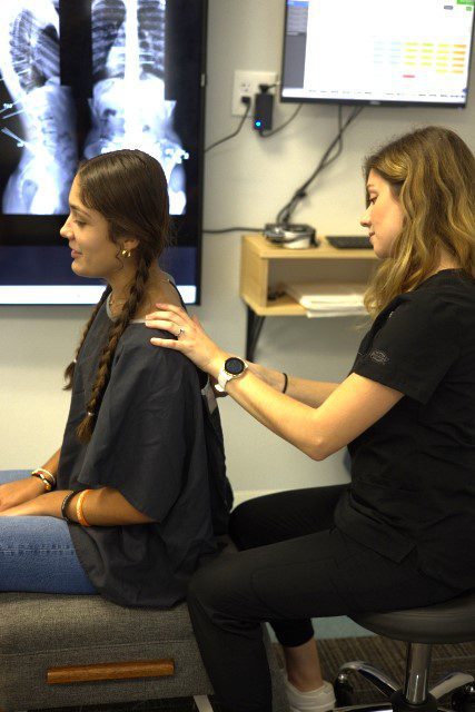 doctor checking a woman's back